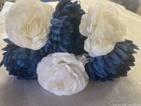 Close-up of blue and white artificial flowers showing flower heads and petals.