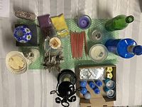 Top-down view showing the full collection of candles, wax burners, wax pellets, decorative bottles, tea light candle holders, and assorted small candles.