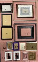 Photo showing 18 assorted frames numbered 1 to 18 arranged on a pink background. Frames vary in size, material and condition.