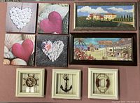 Group photo of all 9 prints including hearts on canvas, framed Tuscany and scuba diving collage, and nautical shadow boxes.