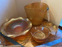 Overview of all four carnival glass items together showing differences in shape and texture