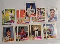 Photo shows 15 Topps baseball cards from 1989 featuring draft picks from different Major League Baseball teams placed on white background.