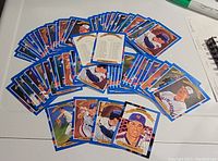 Two full collections of 26 cards from the 1990 Donruss Diamond Kings Watercolors baseball series arranged on a white surface showing colorful player images.