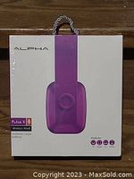 Front of the ALPHA Pulse X headphones box showing purple Wireless/Wired headphones branding and packaging.
