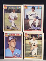 Front view of the four Topps baseball cards arranged in a grid showing players and card details.