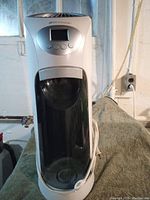 Front view of Bonaire humidifier showing full unit with digital display, water tank, and power cord.