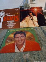 Three Elvis vinyl albums: Tribute to Elvis, self-titled Elvis, and Elvis Gold Records Vol. 4, showing front covers.