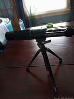 Photo of the full telescope mounted on tripod on a table indoors.