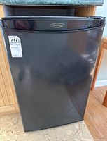 Front view of black Danby Designer bar fridge with visible Danby logo.