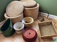 Overview of all items in the lot showing the 2 woven grass baskets, planter pots, metal jug, and rectangular storage baskets