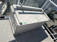 Closed exterior view of beige Suncast storage box on balcony