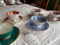 Overview of all six tea cup and saucer sets showing Aynsley and Royal Bayreuth pieces with tags.