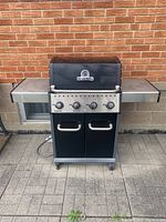 Full front view of grill with closed lid and side shelves extended
