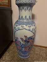 Front angle showing detailed bird and floral painted decoration on ceramic floor vase.