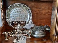 Photo shows Yanda three-arm candle holder, two metal wine cups, Victorian style hammered metal plate tray with scalloped edges, a round metal plate tray, and a Novapeltro marked round metal bowl with lid with minor damage.