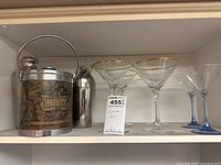 Cocktail set showing ice bucket, shaker, and all glasses together on shelf