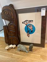 Overview of all items: framed print, wood carving, soapstone sculptures, three cups