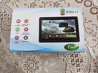 Original packaging box showing 7 inch Android tablet with Android Jelly Beans logo and feature icons.