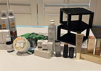 Overview of makeup, skincare, razor and accessories. Includes Agnes B. bottles, Dove soaps, and various boxed products.