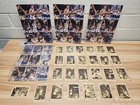 Front view of all individual and uncut sheet cards laid out on table