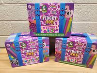 Three YoYo Fidgets Mystery Boxes stacked, showing front and side branded packaging and colorful design.