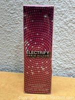 Front of the perfume box showing pink/mosaic tile design with brand and perfume name.