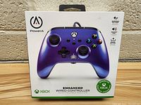 Front view of new PowerA Spectra Infinity Xbox controller in box showing front of controller in purple color.