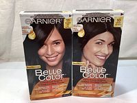 Front view of the two Garnier Belle Color hair dye boxes 11 Very Intense Black and 10 Soft Black with images of women with black hair.