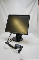 Full front and stand view of the NEC Multisync 1970NX monitor with USB adapter and cables.