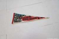 Front side of the Salem Witch Museum pennant showing colored graphics with text and design.