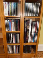 Full view of two wooden CD shelves showing a large assortment of CDs and box sets including 'Fat Waller', 'Abba', and 'The Bridges - SPF'.