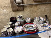 Overview of full dishware set showing plates, bowls, cups, creamer and sugar bowl