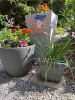 Photo showing all three resin garden planters arranged outdoors with plants.