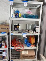 Side view of shelving unit showing items on top shelves and labels on posts.