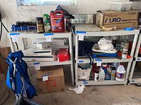 Overall view of the shelving units packed with cleaning supplies, automotive fluids, boxes, and various household items