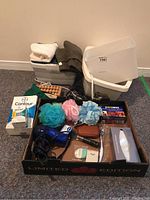 Full lot overview showing foot bath, liners, bath sponges, and boxed items.