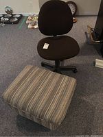Photo showing brown fabric office chair and rectangular striped ottoman on casters.