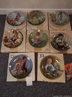 Eight collector plates arranged with original boxes visible. Plates measure about 8.5 inches wide each and depict nursery rhyme characters.