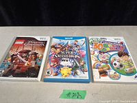 Photo of three Nintendo Wii game cases: LEGO Pirates of the Caribbean, Super Smash Bros. Wii, and Family Mini Sports Game, showing front cover artwork and condition.