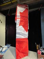 Photo of the folded Canadian flag showing the red maple leaf section and size indication.