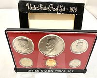 Red-backed plastic casing containing six 1976 Bicentennial US proof coins with reflective proof finish.
