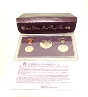 Photo shows the 1991-S US proof coin set inside a clear plastic holder containing five coins on a purple background with silver lettering.