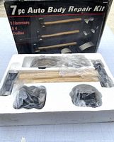 View of the 7 piece auto body repair kit in original packaging with protective plastic on tools.