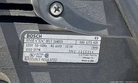 Close-up photo of the label showing Bosch model 87450 belt sander specifications and serial number.