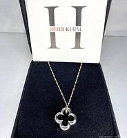 Sterling silver clover pendant necklace displayed in branded Heidi Klum box.