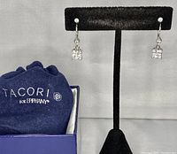 Pair of sterling silver leverback earrings displayed on black stand next to navy blue Tacori for Tiffany lined box and cloth bag