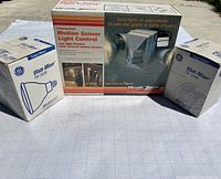 Heath Zenith Motion Sensor Light Control kit box with product details and images showing automatic light sensor use, with original packaging.