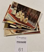 Stack of postcards showing wedding procession and bridesmaids in traditional attire