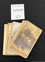 Stack of small vintage CDV photographs showing a young girl sitting and holding flowers, sepia tone, mounted on cardstock with imprint 'Allen & Co, 60 Neville St, Southport'