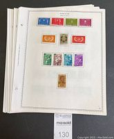 Stack of 24 single-sided stamp album pages containing Surinam stamps